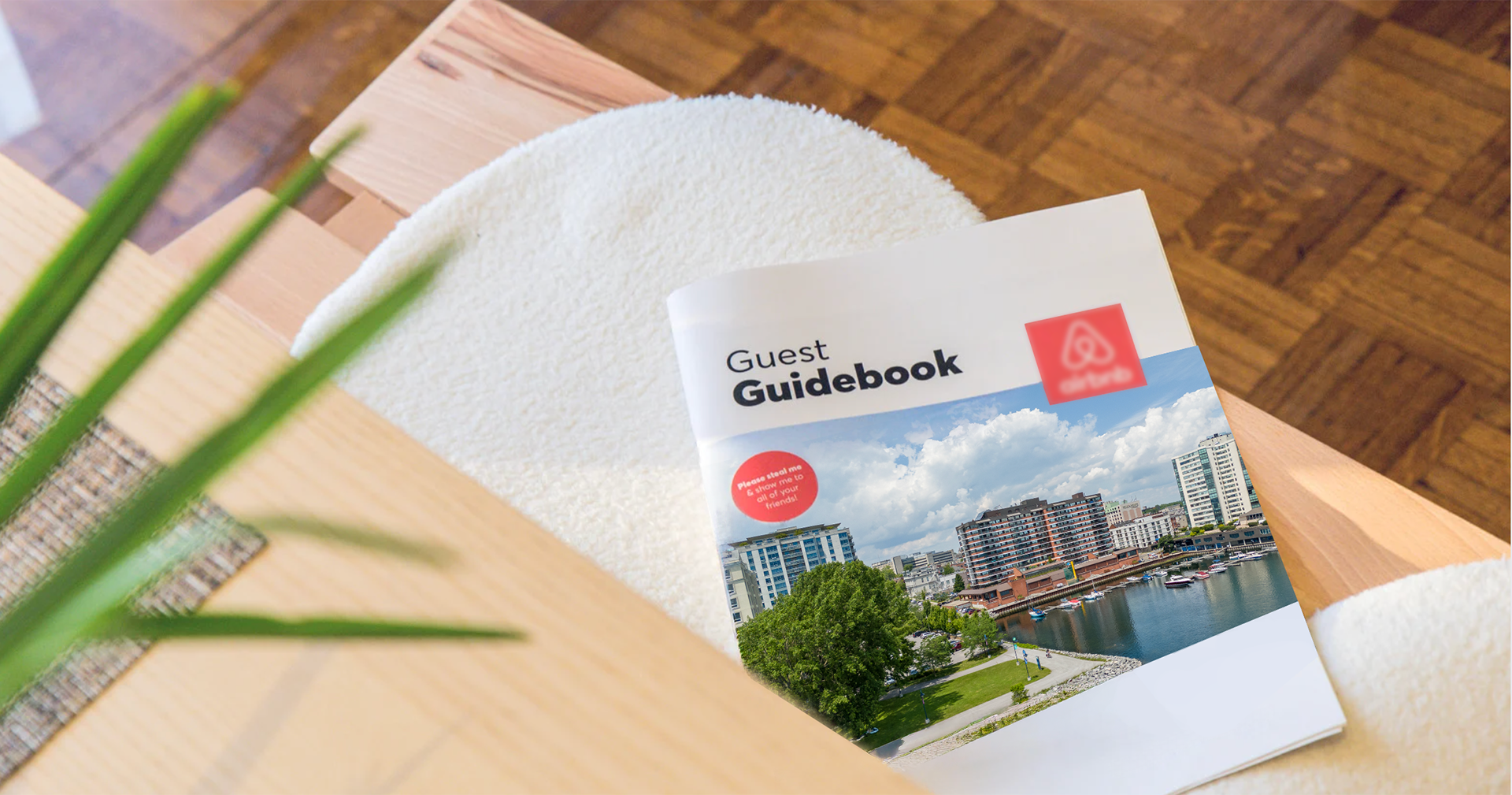 Airbnb guest guidebook on a modern wood table inside a short-term rental, photographed by She Shoots Inc. in Kingston Ontario.