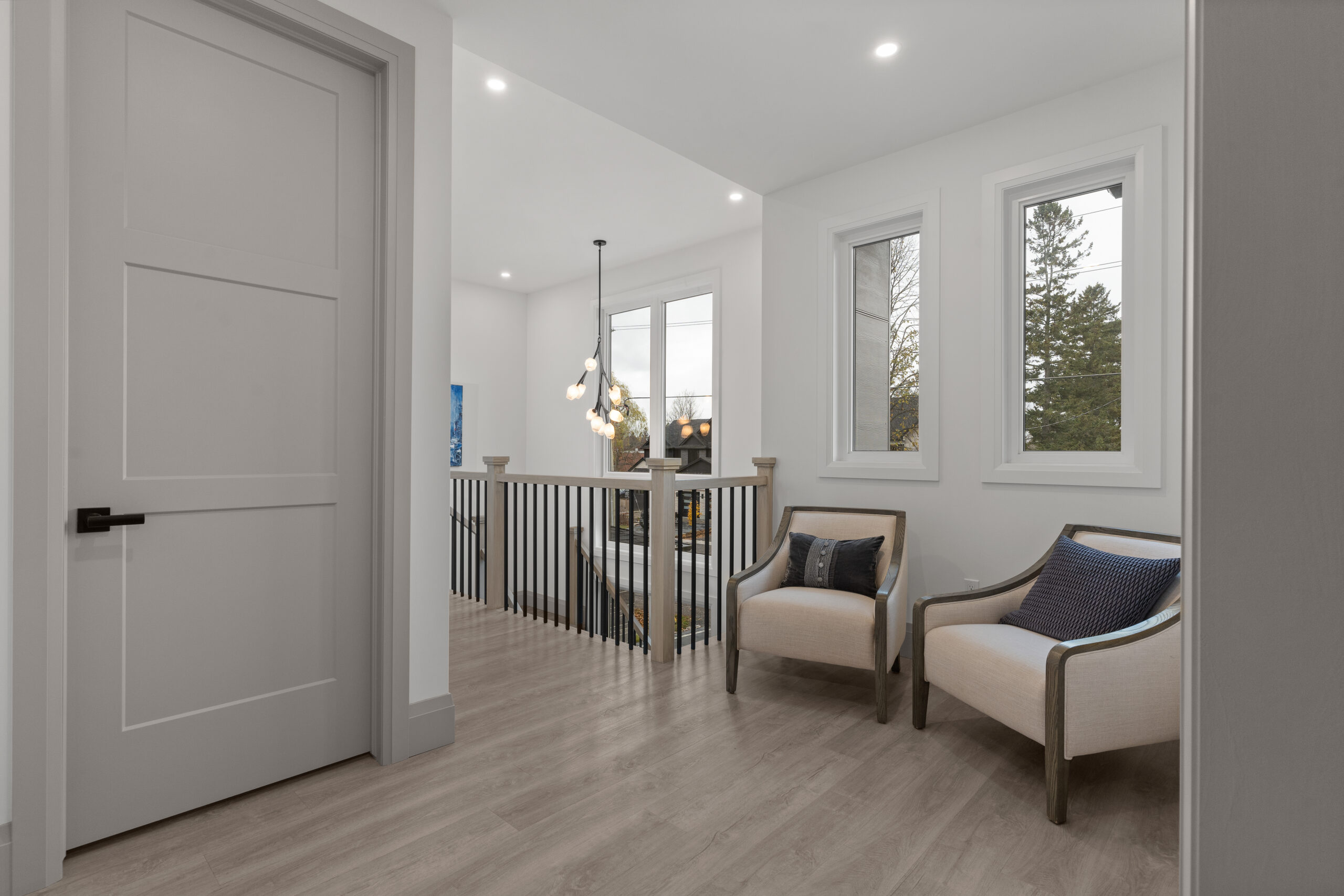 Built-in wood cabinetry home office with black countertop and large wall clock photographed for a Kingston builder