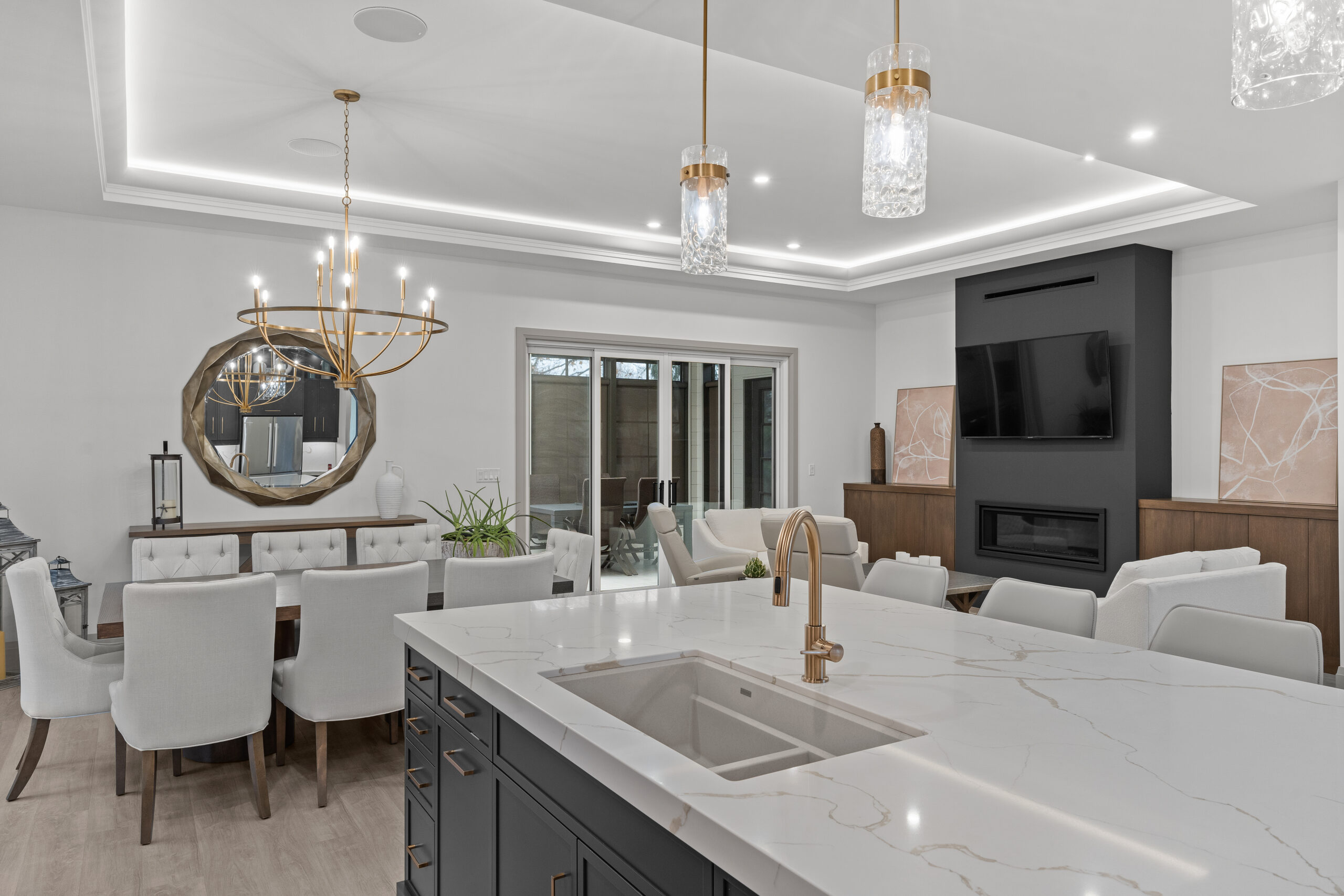 Custom kitchen with dark cabinetry, gold fixtures, and white island countertop photographed for a Kingston builder portfolio