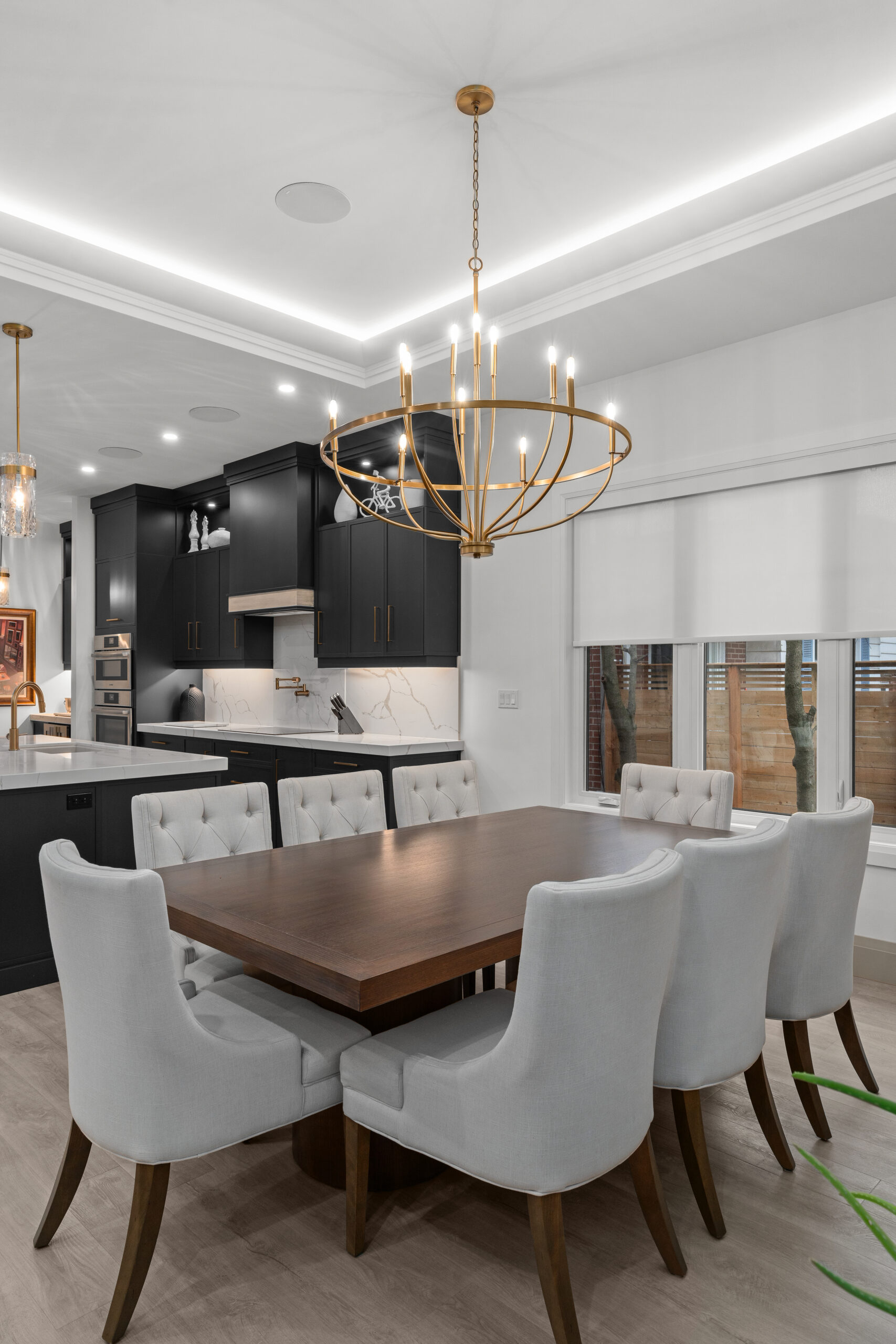 Custom kitchen with dark cabinetry, gold fixtures, and white island countertop photographed for a Kingston builder portfolio