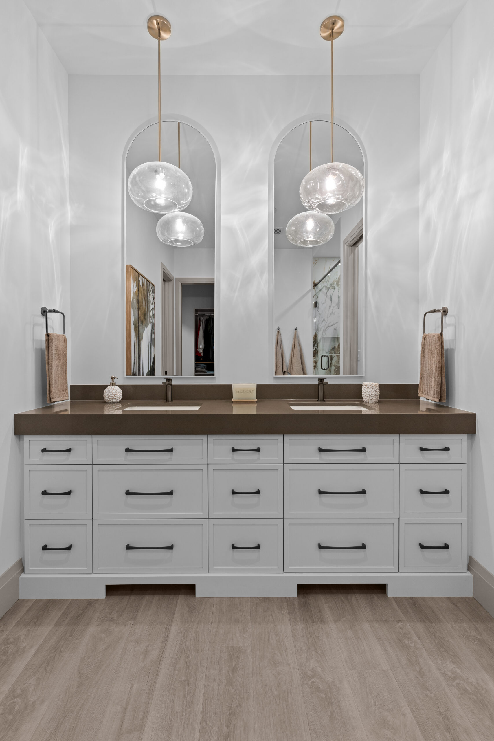 Modern bathroom with glass shower, neutral tile, and black fixtures photographed for a Kingston home builder