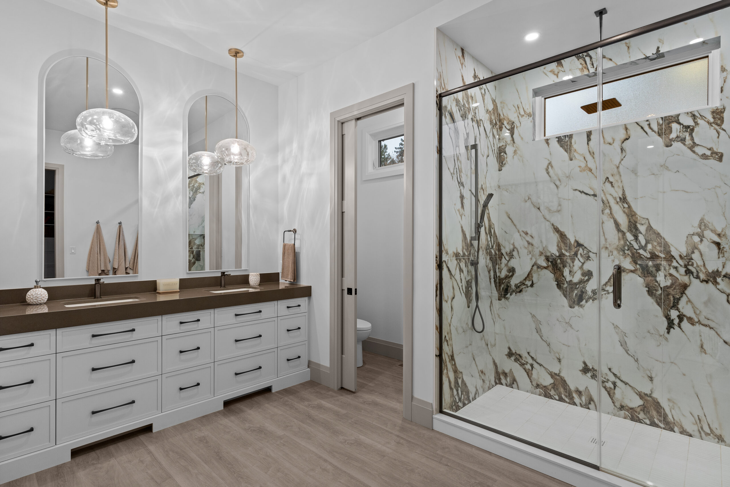 Ensuite bathroom featuring dual vanity and marble shower walls photographed for a Kingston builder portfolio