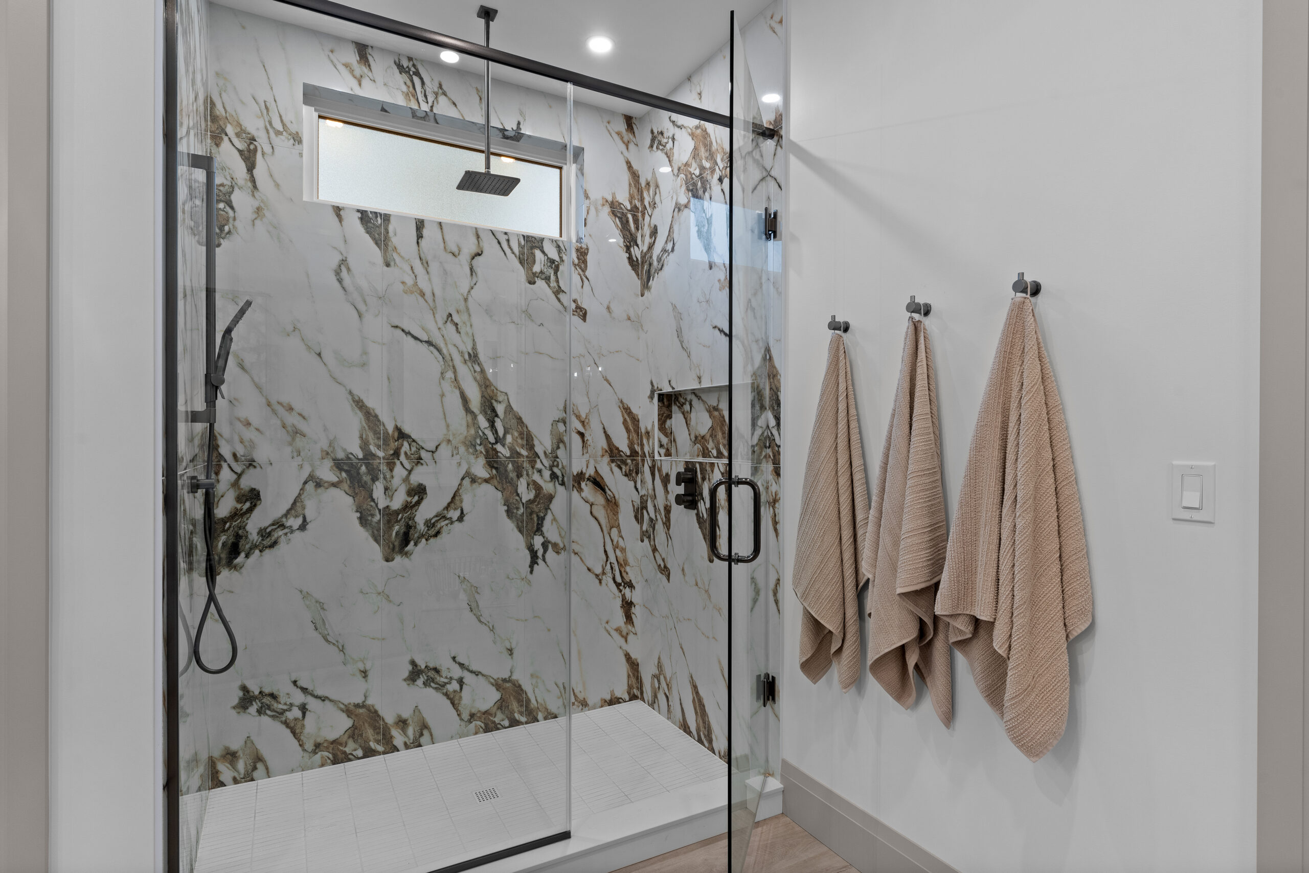 Ensuite bathroom featuring dual vanity and marble shower walls photographed for a Kingston builder portfolio