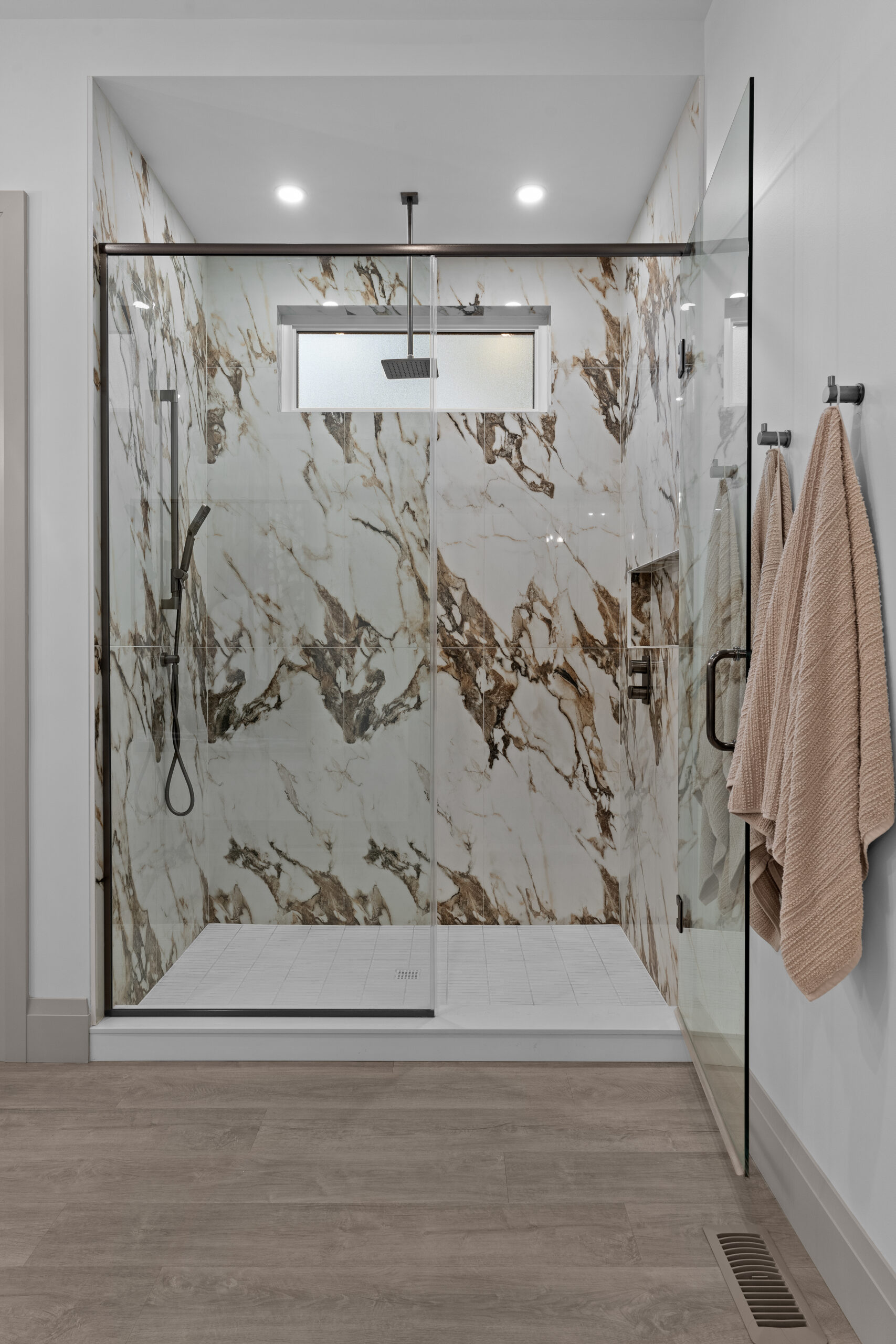 Ensuite bathroom featuring dual vanity and marble shower walls photographed for a Kingston builder portfolio