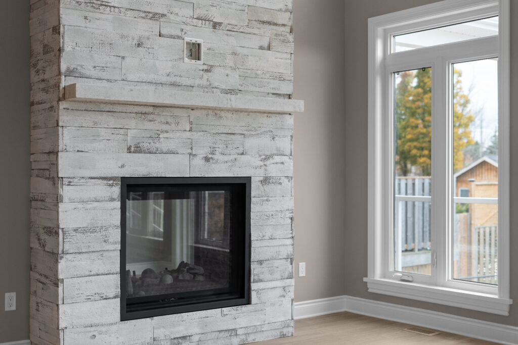 Contractor portfolio fireplace with whitewashed stone surround